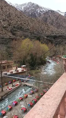 a river with a bunch of umbrellas on the shore at Riad Amegrad in Marrakech
