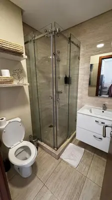 a bathroom with a shower and a toilet and a sink at Studio sur golfe et piscine in Marrakech