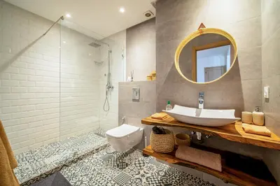 a bathroom with a sink and a toilet and a mirror at Perle Rare à Bab Ighli Marrakech in Marrakech