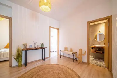 a white room with a sink and a table and a mirror at Perle Rare à Bab Ighli Marrakech in Marrakech