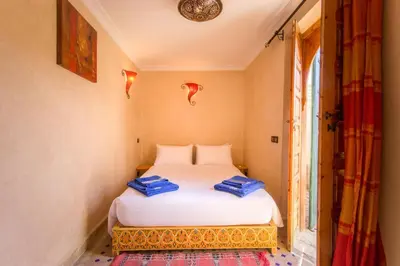 a bedroom with a bed and a window at Riad Colette EXCLUSIF - Médina - Breakfast - Wifi in Marrakech