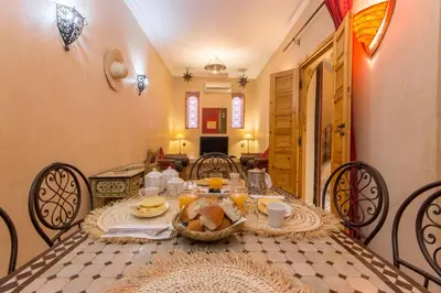 a table with a plate of food on it at Riad Colette EXCLUSIF - Médina - Breakfast - Wifi in Marrakech