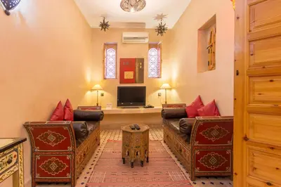 a living room with two couches and a tv at Riad Colette EXCLUSIF - Médina - Breakfast - Wifi in Marrakech