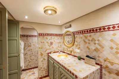 a bathroom with a sink and a mirror at Riad Dar Hamid Hotel & Spa in Marrakech