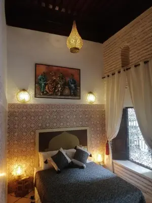 a bedroom with a bed in a room with lights at Riad Dar Hamid Hotel & Spa in Marrakech