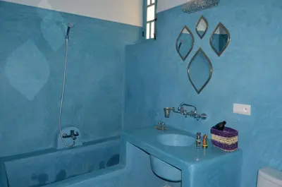 a blue bathroom with a sink and a tub at Riad Dar Hamid Hotel & Spa in Marrakech