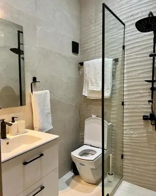 a bathroom with a toilet and a sink and a shower at Dar Sanaa Marrakech in Marrakech