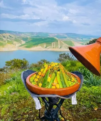 a bowl of vegetables on a grill on a mountain at Dar Sanaa Marrakech in Marrakech