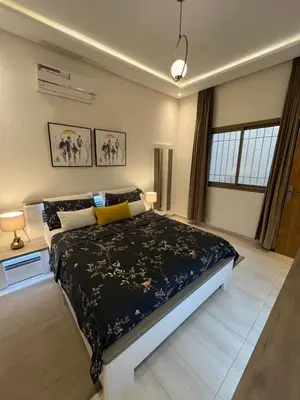a bedroom with a large bed with a black comforter at Dar Sanaa Marrakech in Marrakech