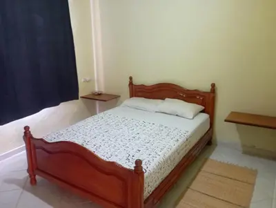 a bedroom with a wooden bed in a room at MAISON de VACANCES in Marrakech
