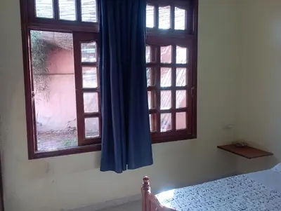 a bedroom with two windows with blue curtains at MAISON de VACANCES in Marrakech