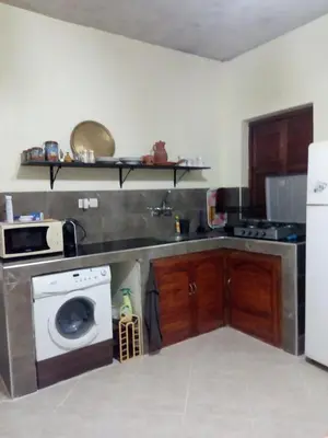 a kitchen with a sink and a washing machine at MAISON de VACANCES in Marrakech