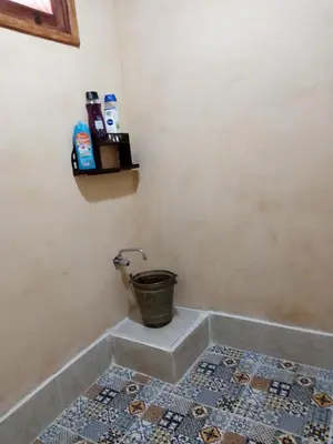 a bathroom with a bucket in the corner of a room at MAISON de VACANCES in Marrakech