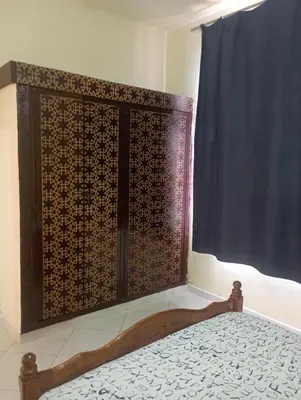 a bed in a room with a window at MAISON de VACANCES in Marrakech