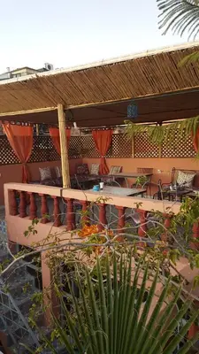 a building with a patio with a table and chairs at Riad De La Semaine in Marrakech