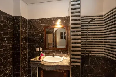 a bathroom with a sink and a mirror at Riad De La Semaine in Marrakech