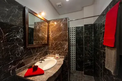 a bathroom with a sink with a red towel on it at Riad De La Semaine in Marrakech