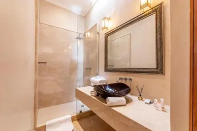 a bathroom with a sink and a shower at Riad Kahena in Marrakech