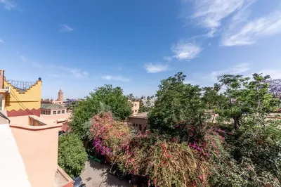 a view from the roof of a building with trees and flowers at Riad Kahena in Marrakech