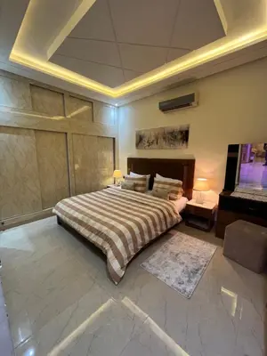 a bedroom with a large bed and a piano at Dar Anass Marrakech in Marrakech
