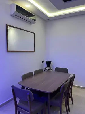 a meeting room with a wooden table and chairs at Dar Anass Marrakech in Marrakech