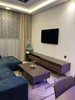 a living room with a couch and a flat screen tv at Dar Anass Marrakech in Marrakech