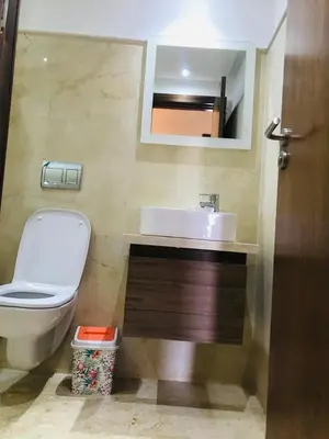 a bathroom with a toilet and a sink and a mirror at SUNNY 48- Appart Cozy -Marrakech-centre in Marrakech