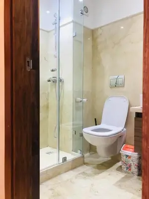 a bathroom with a toilet and a glass shower at SUNNY 48- Appart Cozy -Marrakech-centre in Marrakech