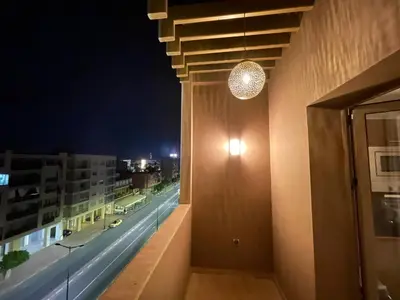 a room with a view of a city at night at NEW SUPER LUXURY APARTMENT (CENTRAL MARRAKECH) in Marrakech