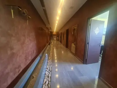 a hallway of a building with a long line of water at Targafit Hotel & Hammam in Marrakech