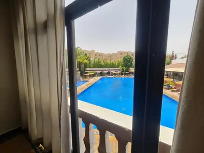 a view of a swimming pool from a window at Targafit Hotel & Hammam in Marrakech