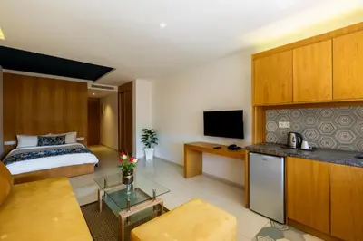 a hotel room with a bed and a television at AppartHotel Atrani in Marrakech
