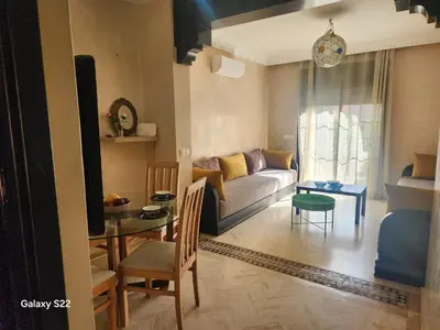 a living room with a couch and a table at Atlas golf in Marrakech