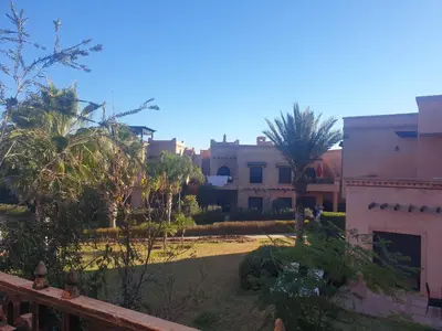 a view of a yard with palm trees and buildings at Atlas golf in Marrakech