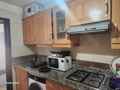 a kitchen counter with a microwave and a stove at Atlas golf in Marrakech