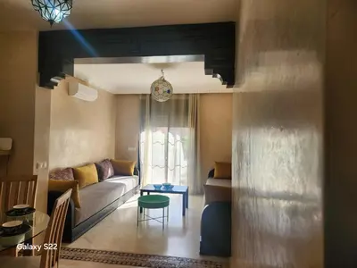 a living room with a couch and a table at Atlas golf in Marrakech