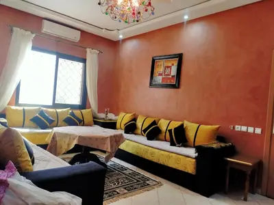 a living room with a couch and a table at Firdaouss apartment in Marrakech