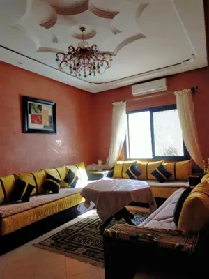 a living room with a couch and a table at Firdaouss apartment in Marrakech