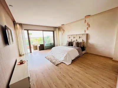 a bedroom with a bed and a wooden floor at Villa golf prestigia marrakech in Marrakech