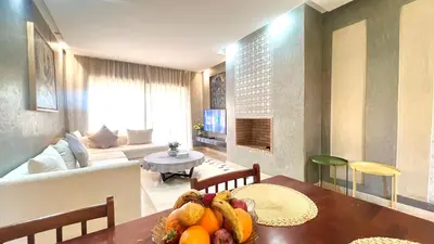 a living room with a table with fruit on it at Prestigia Appartement de luxe in Marrakech