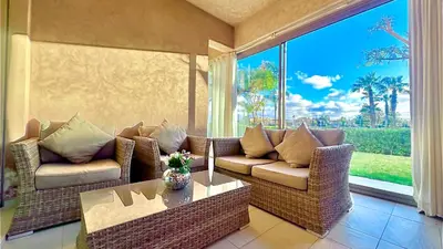 a living room with two couches and a table at Prestigia Appartement de luxe in Marrakech