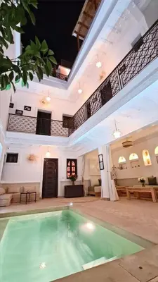 a pool in the middle of a living room with a large room at Riad Alizé in Marrakech
