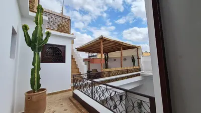 a cactus sits on the balcony of a house at Riad Alizé in Marrakech