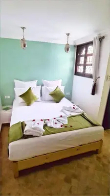 a bedroom with a bed with towels on it at Riad Alizé in Marrakech