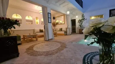 a large living room with a couch and a table at Riad Alizé in Marrakech