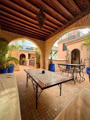 a patio with a table and chairs on it at Riad Bonheur in Marrakech