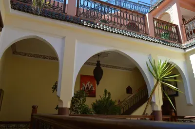 a building with arches and a balcony at Riad Bonheur in Marrakech