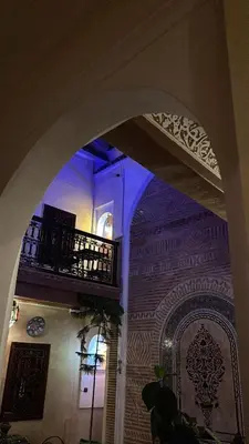 an archway in a building with a balcony at Riad Bonheur in Marrakech