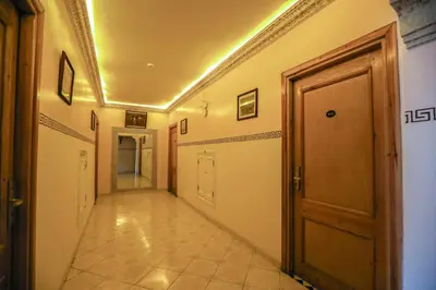 a hallway with a door and a tile floor at Hotel Majorelle in Marrakech
