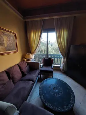 a living room with a couch and a table at Palmeraie Village in Marrakech